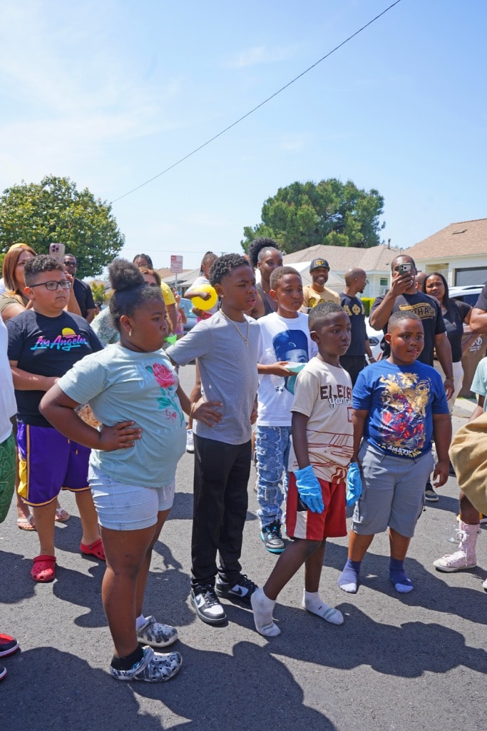 Children and community members gathered watching Field Day activities